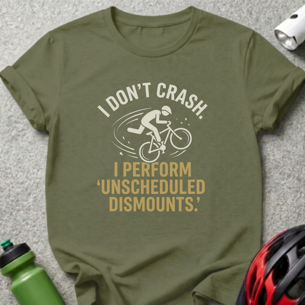 Olive t-shirt with white text "I DON'T CRASH. I PERFORM UNSCHEDULED DISMOUNTS." and cyclist graphic.