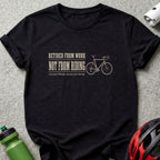 Black t-shirt with "Retired From Work Not From Riding" text and bicycle graphic.