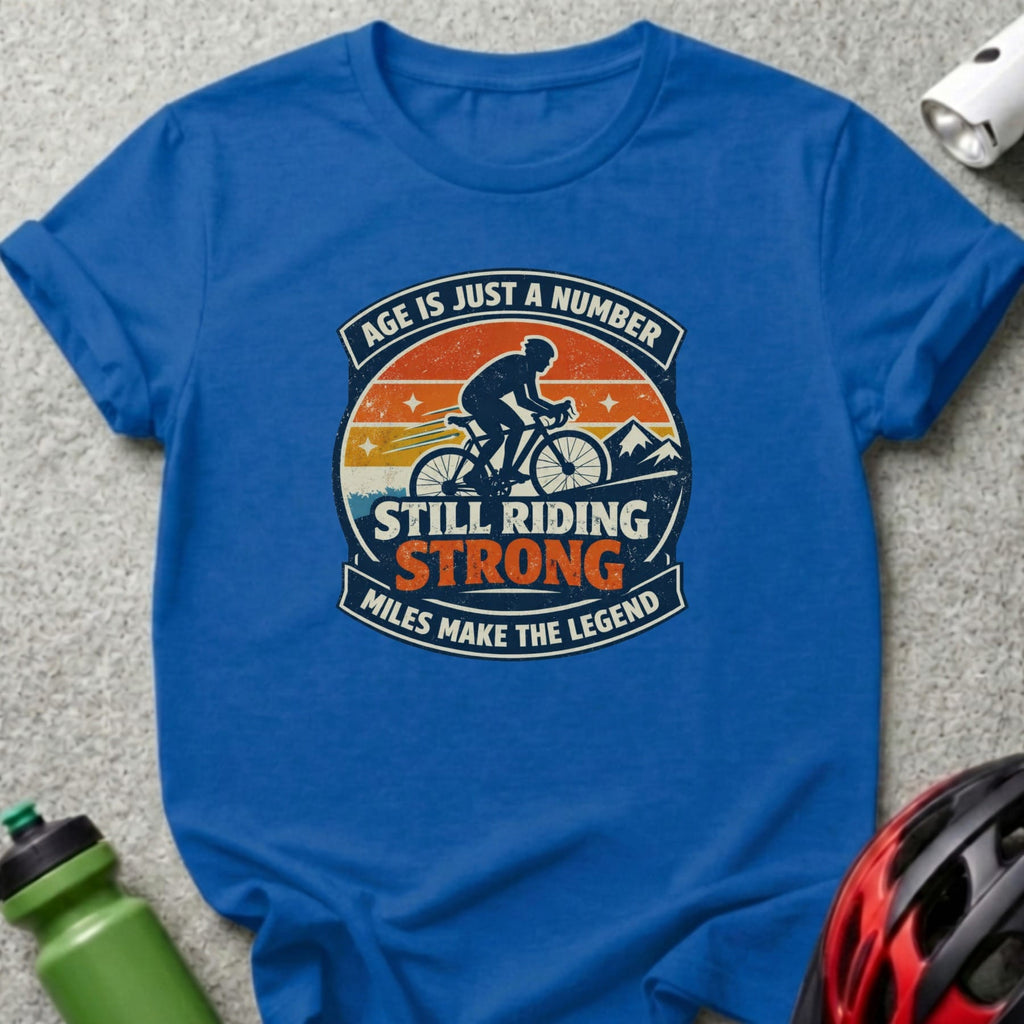 Blue t-shirt with "Age is just a number, still riding strong, miles make the legend" graphic.