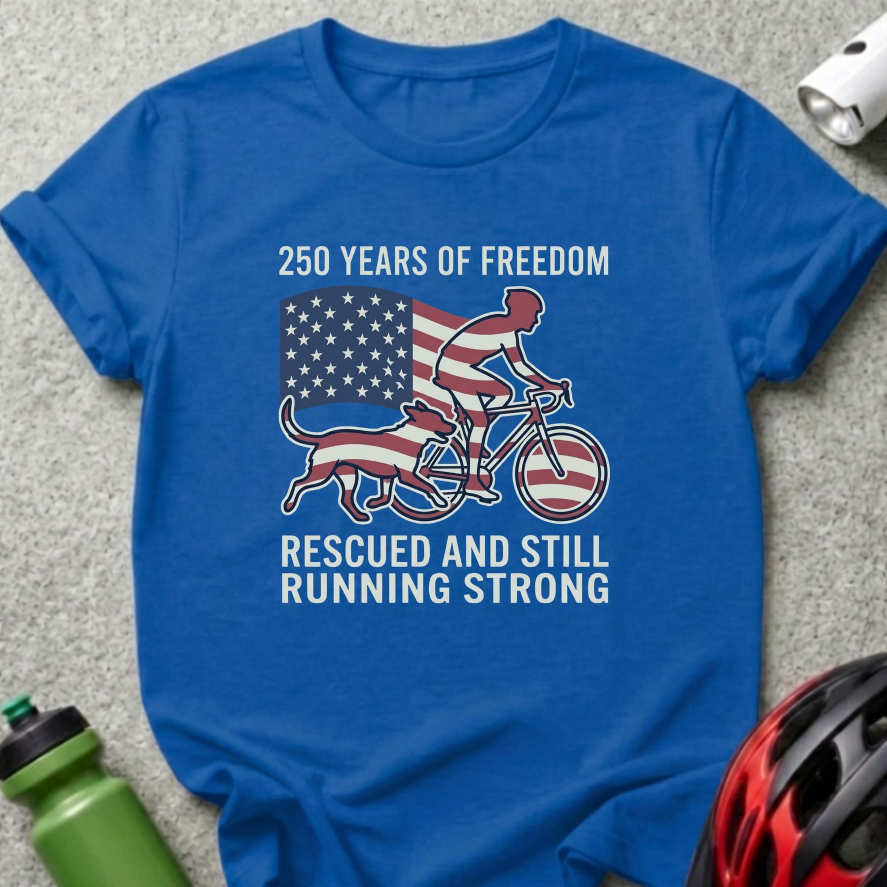 Blue t-shirt with "250 Years of Freedom" and cyclist with dog graphic.