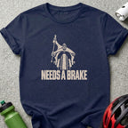 Navy blue t-shirt featuring a bicycle graphic and the text NEEDS A BRAKE.