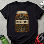 T-shirt with a graphic of bicycles inside a medicine bottle labeled "MEDICINE".