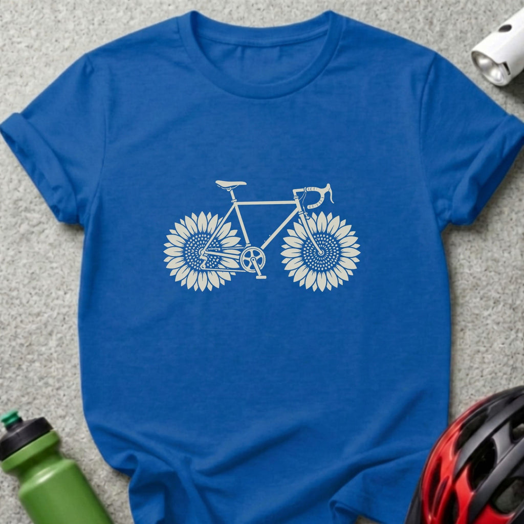 A royal blue t-shirt featuring a white graphic of a bicycle with sunflowers as wheels.
