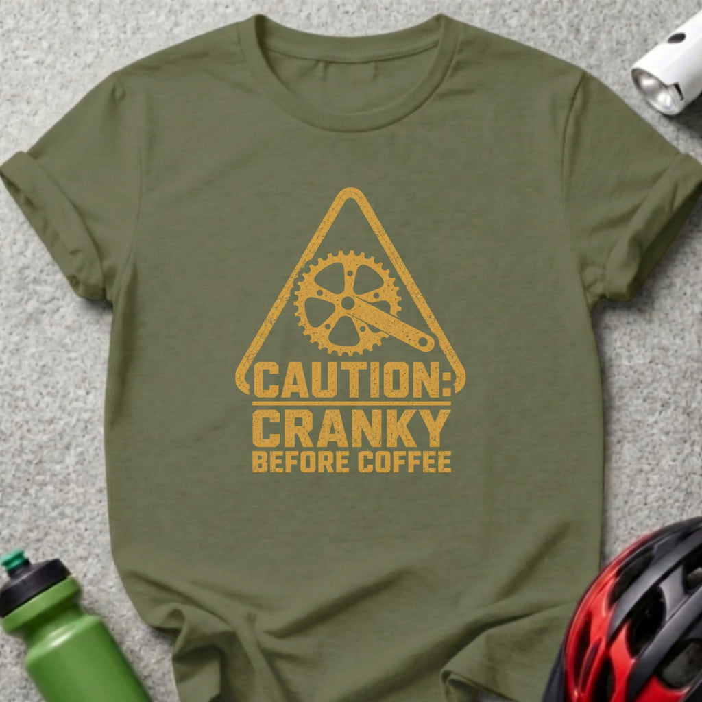 Olive t-shirt with yellow bicycle gear symbol and text "Caution: Cranky Before Coffee".