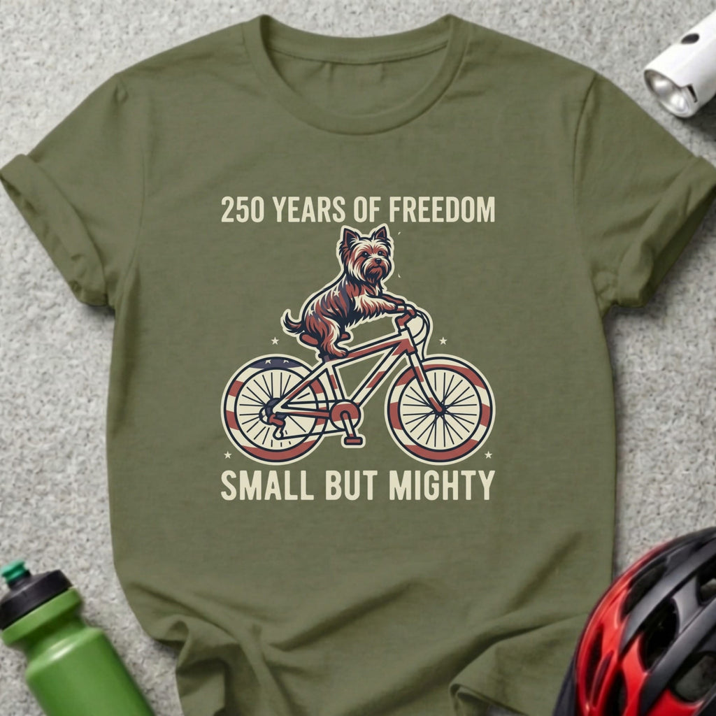 Green t-shirt with dog on bicycle, "250 Years of Freedom Small But Mighty."