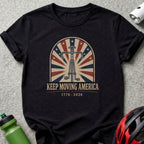 Black t-shirt with "Keep Moving America" text and bicycle wheel design.