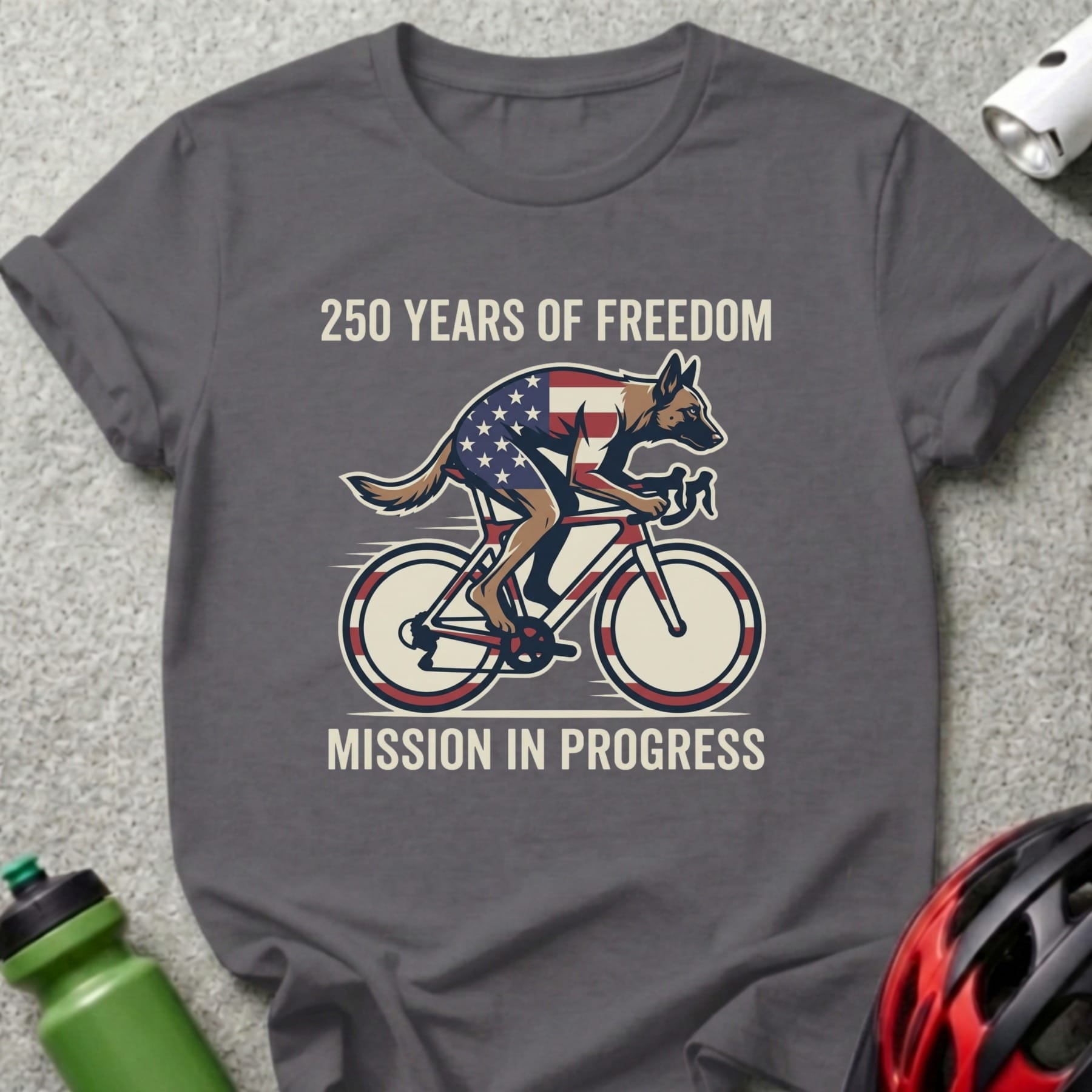 Grey t-shirt with dog on bicycle, "250 Years of Freedom Mission in Progress."