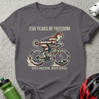 Dog in American flag bandana rides a bicycle with patriotic stars and stripes.