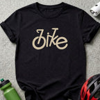 Black t-shirt with a beige brushstroke "bike" graphic and cycling accessories.