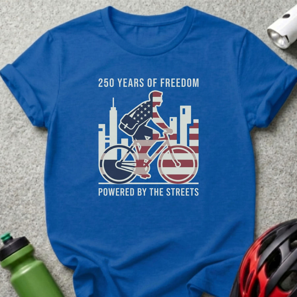 Blue t-shirt with cyclist illustration and text "250 Years of Freedom Powered by the Streets".