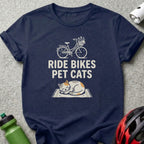 Navy t-shirt with "Ride Bikes Pet Cats" text and bicycle and sleeping cat graphic.