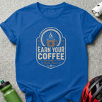 Blue t-shirt with "Earn Your Coffee - Ride First" text and bicycle wheel graphic.