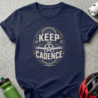 Navy t-shirt with "Keep The Cadence" text and bicycle gear graphic.