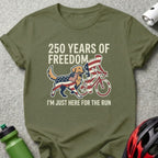 Green t-shirt with "250 Years of Freedom" and dog with flag cycling.