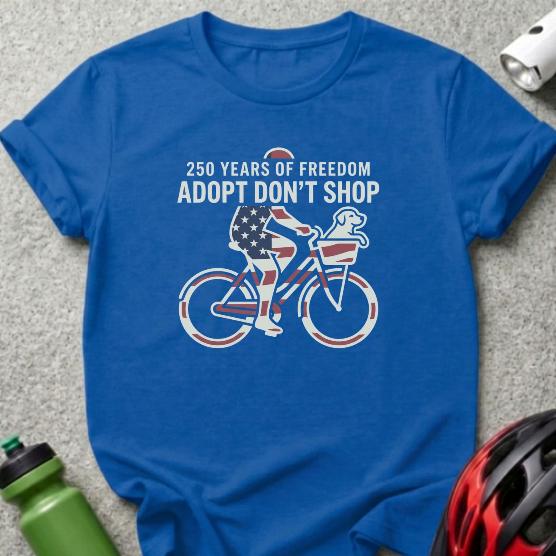 T-shirt with graphic of dog on bicycle celebrating 250 Years of Freedom Adopt Don't Shop.