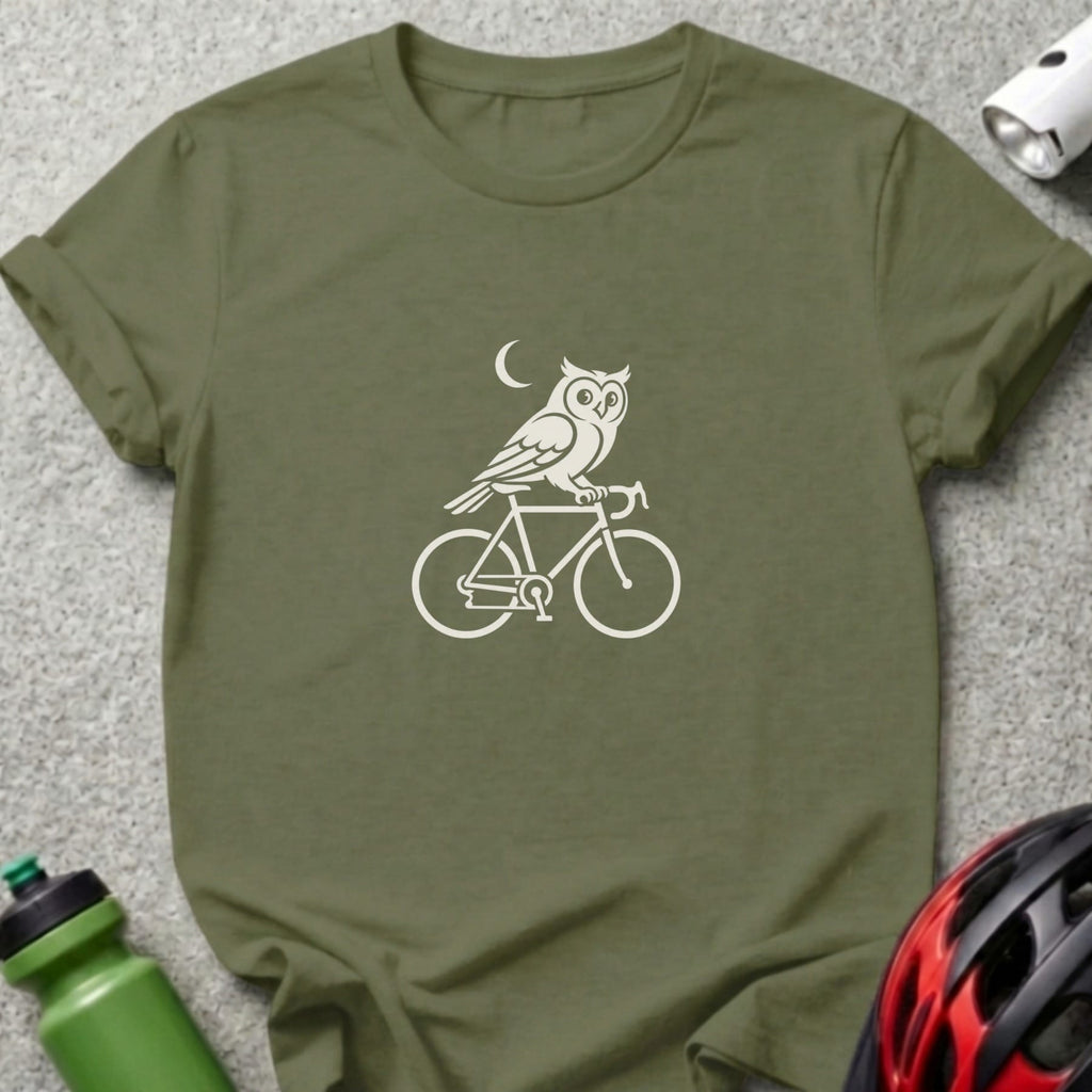 Olive green t-shirt with a white graphic of an owl riding a bicycle under a crescent moon.