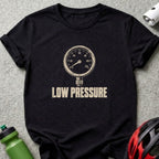 A black t-shirt featuring a distressed white graphic of a pressure gauge and the text LOW PRESSURE.
