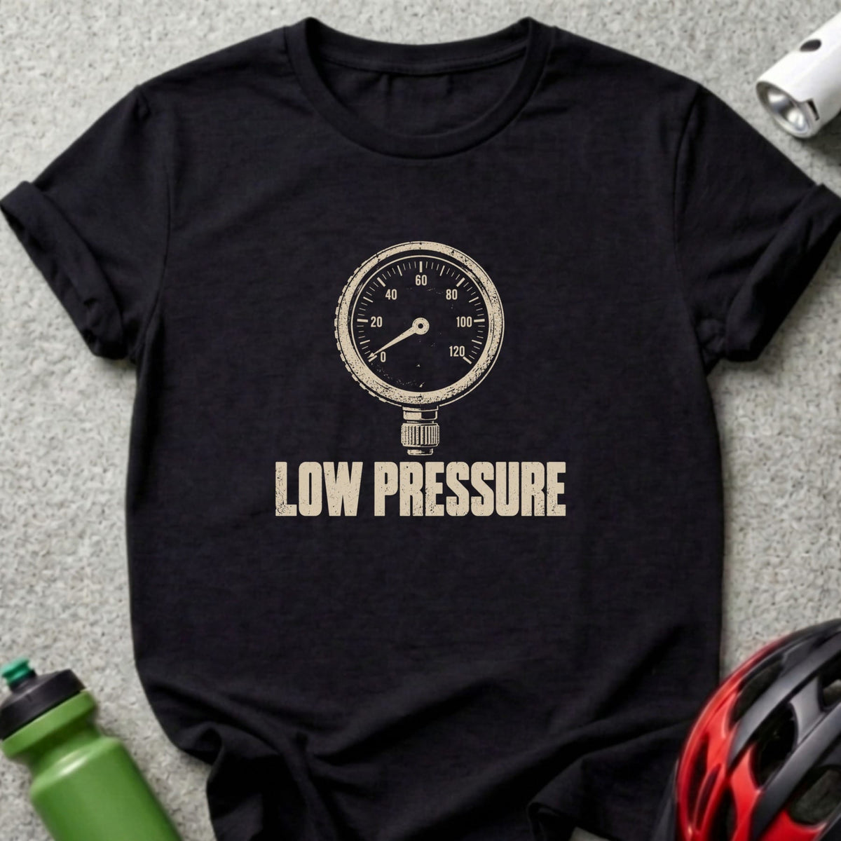 A black t-shirt featuring a distressed white graphic of a pressure gauge and the text LOW PRESSURE.