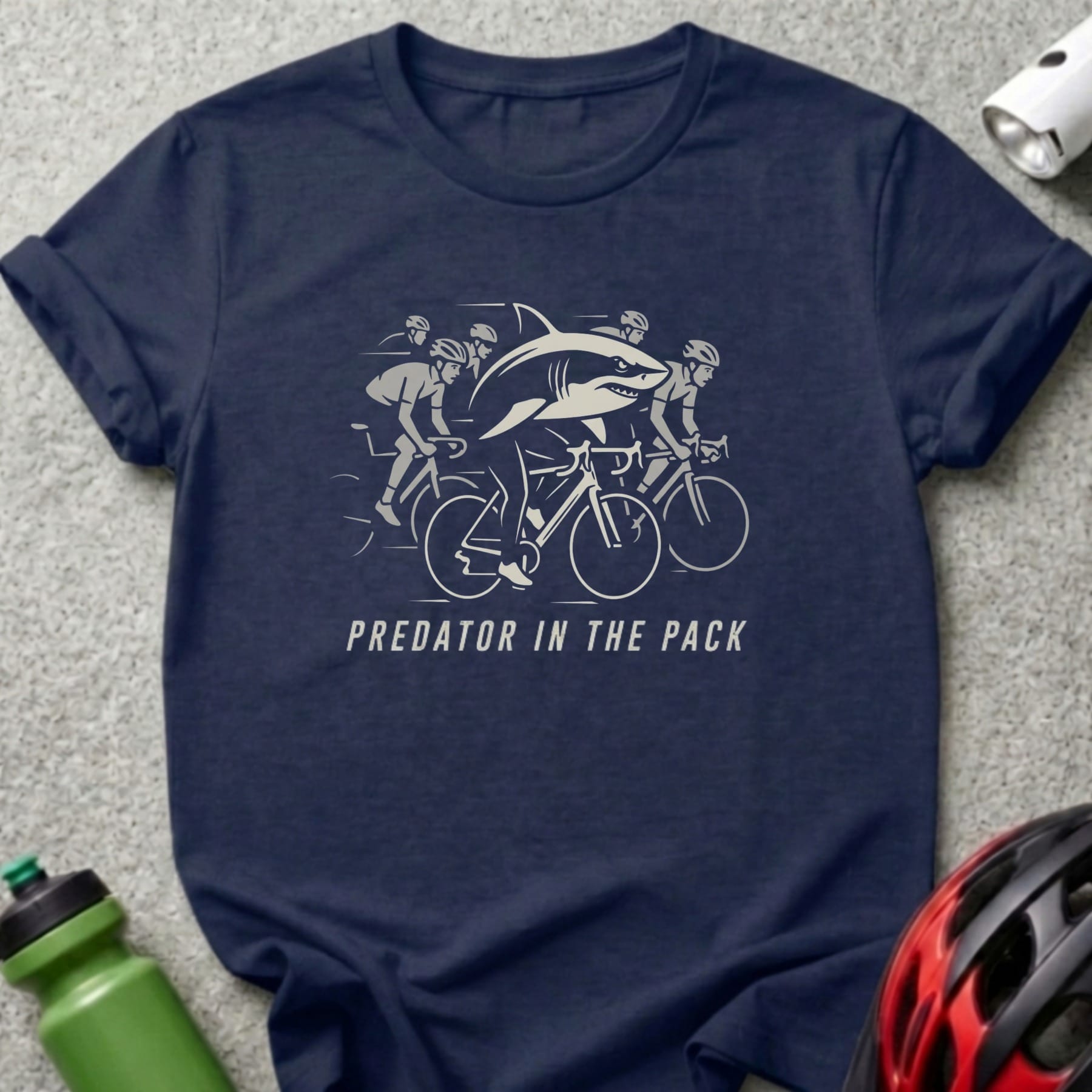 Navy t-shirt with "Predator in the Pack" text and cyclists being chased by a shark.