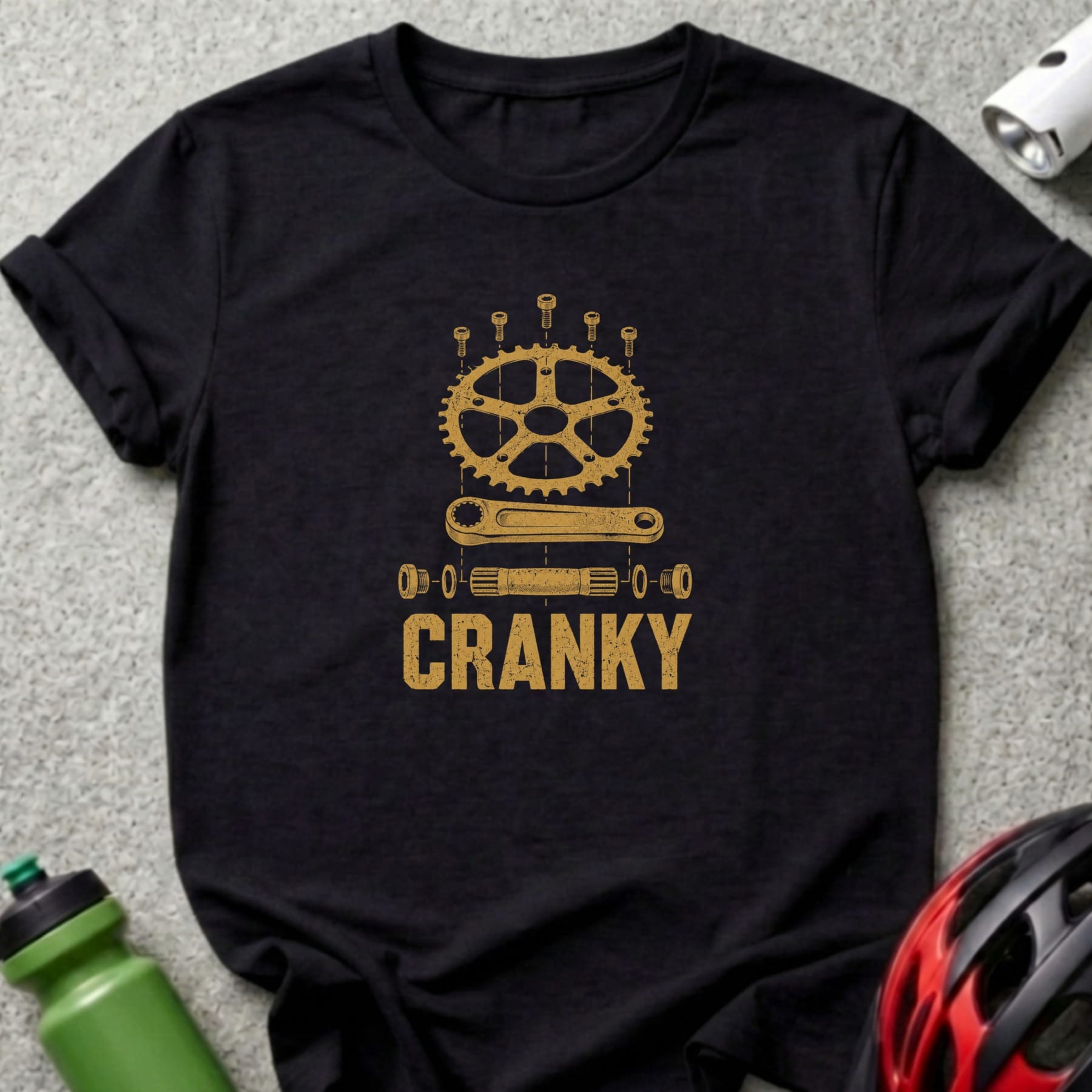 Black t-shirt with gold graphic of bicycle crankset parts and "CRANKY" text.