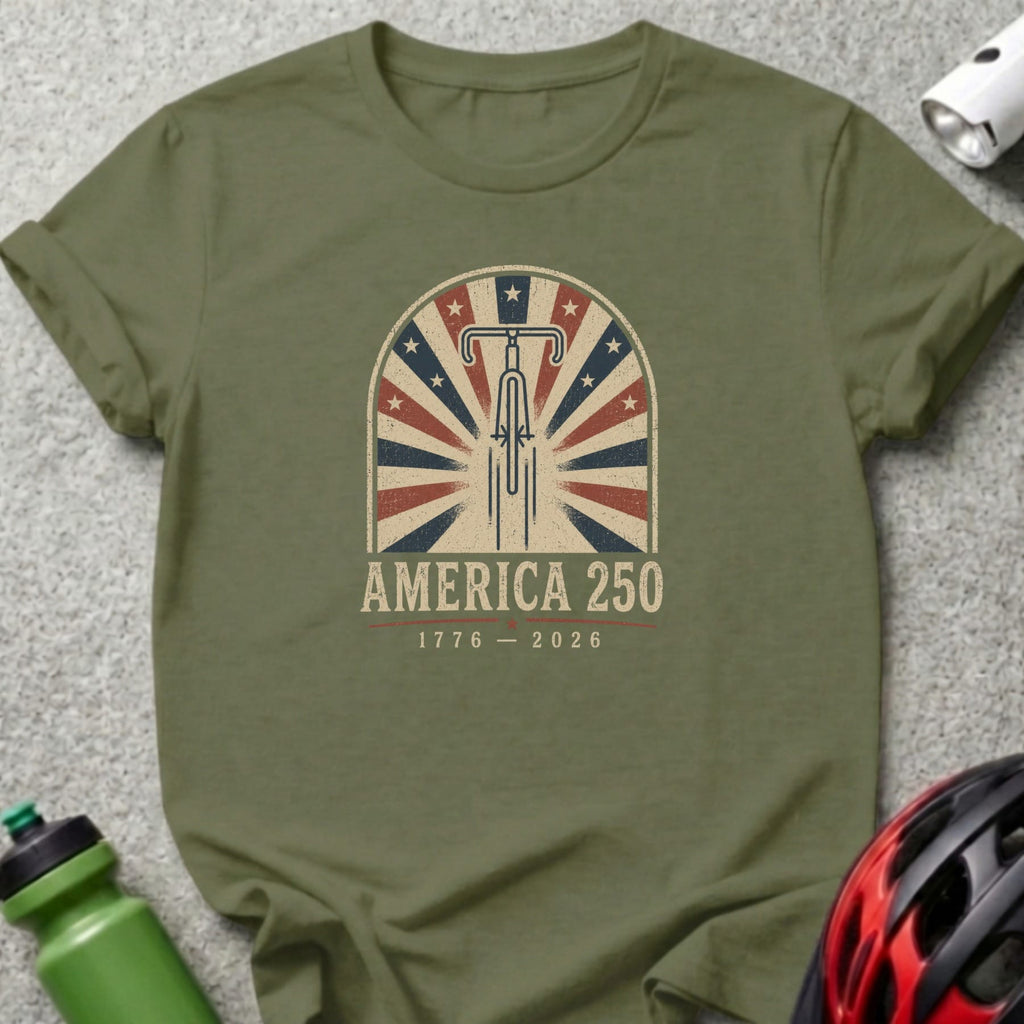 Olive green t-shirt with "AMERICA 250" text and a stylized sunburst behind a bicycle.