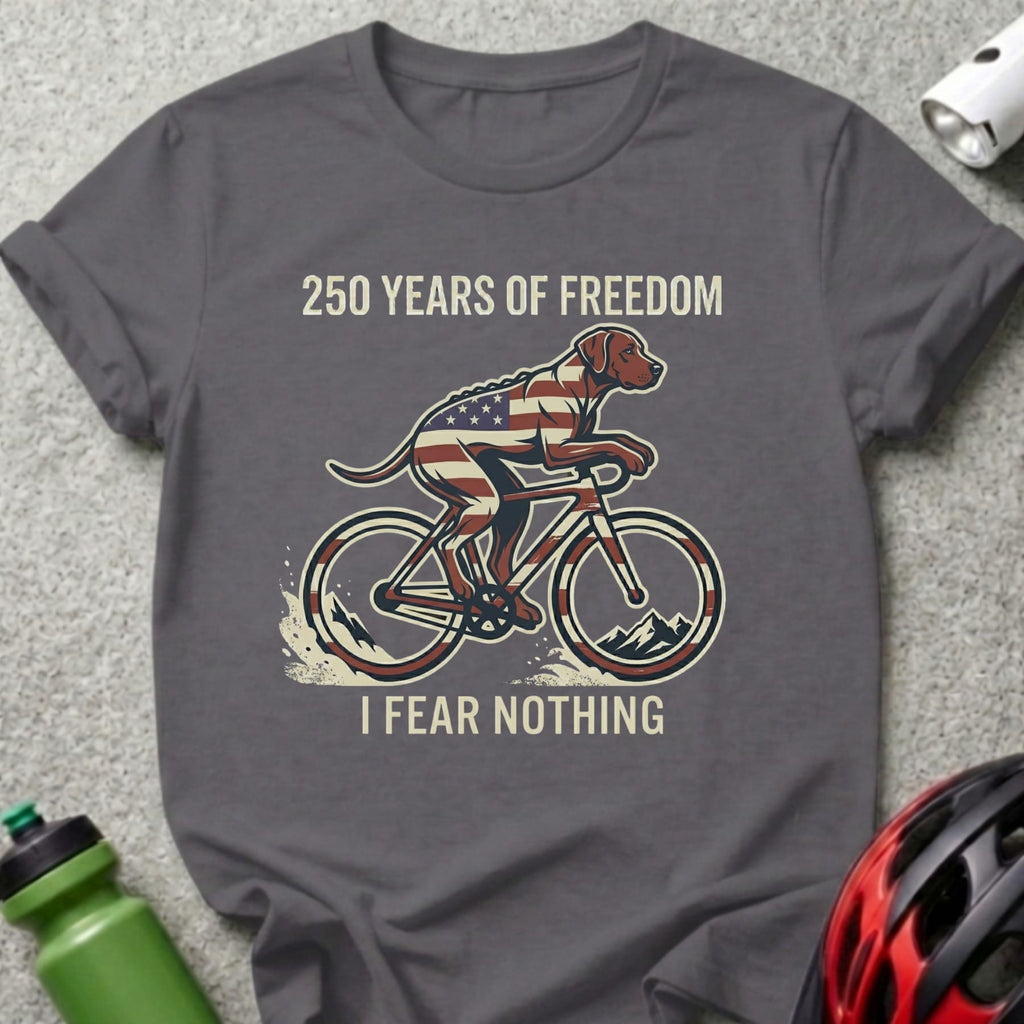 Dog wearing American flag bandana rides bicycle with text "250 Years of Freedom, I Fear Nothing".
