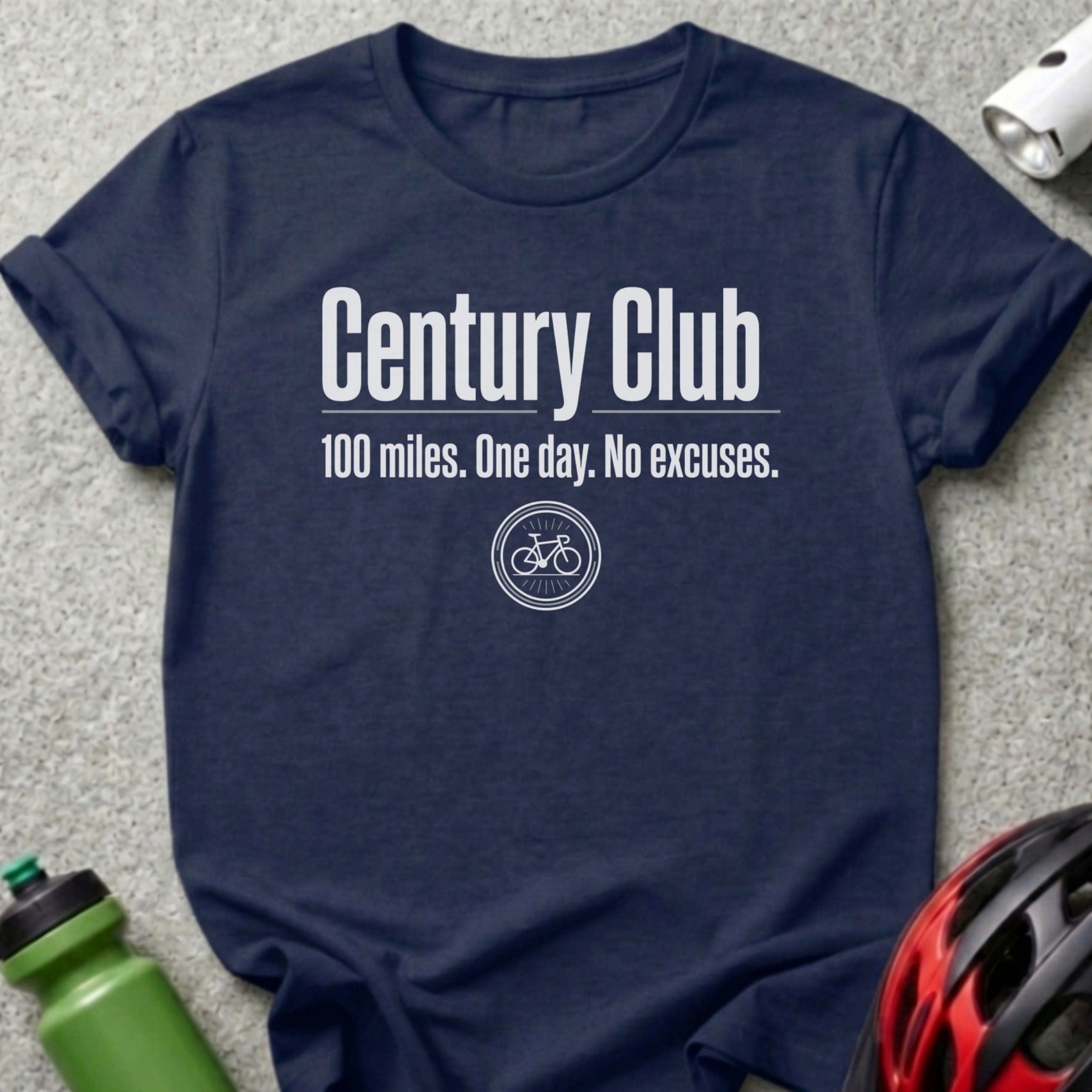 Navy t-shirt with "Century Club 100 miles. One day. No excuses." and bicycle graphic.