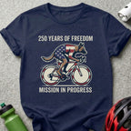 Navy t-shirt with American flag cyclist, "250 Years of Freedom Mission in Progress".