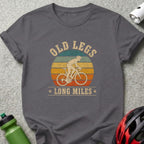 T-shirt with vintage graphic of cyclist and text "OLD LEGS LONG MILES."