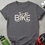 Dark grey t-shirt with beige "BIKE" text graphic and bicycle outline.