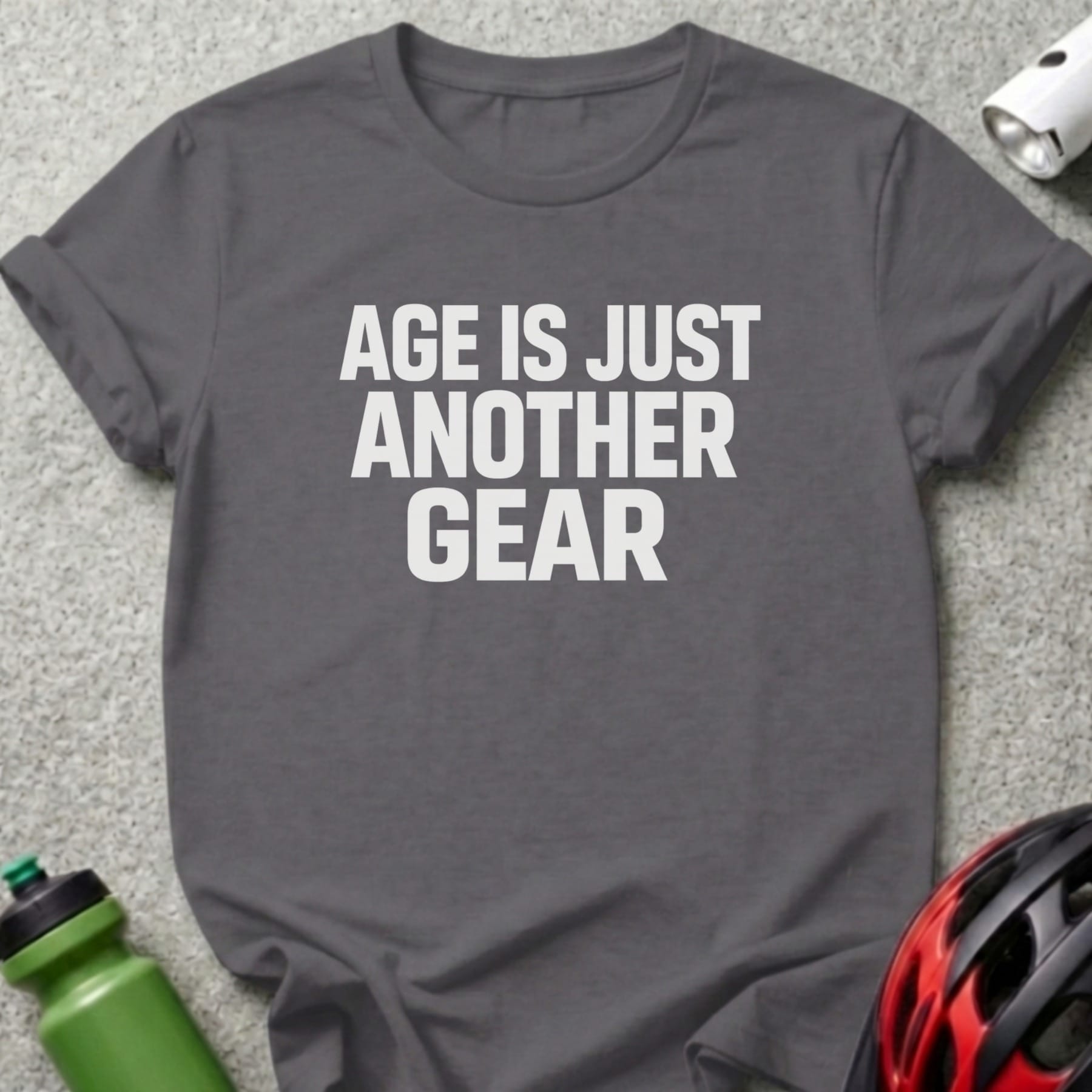 Dark gray t-shirt with white text "AGE IS JUST ANOTHER GEAR".