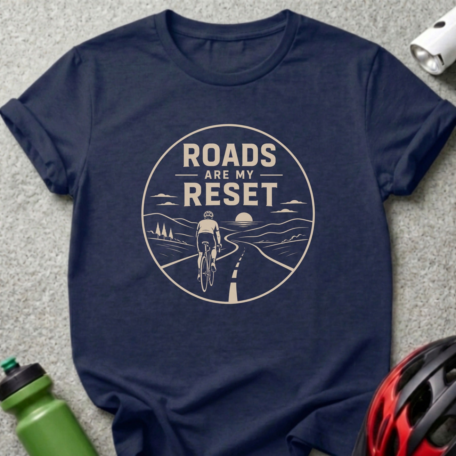 Dark blue t-shirt with a circular graphic of a cyclist on a winding road and text.