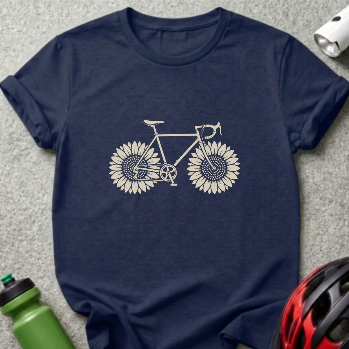 A dark blue t-shirt printed with a graphic of a bicycle with sunflowers for wheels.