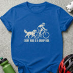 Royal blue t-shirt featuring a white graphic of a dog running alongside a cyclist and the text EVERY RIDE IS A GROUP RIDE.