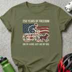 Olive green t-shirt with "250 Years of Freedom" and cyclist with flag, dog.
