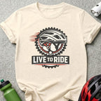Cream t-shirt with "Live to Ride" text and bicycle helmet graphic.