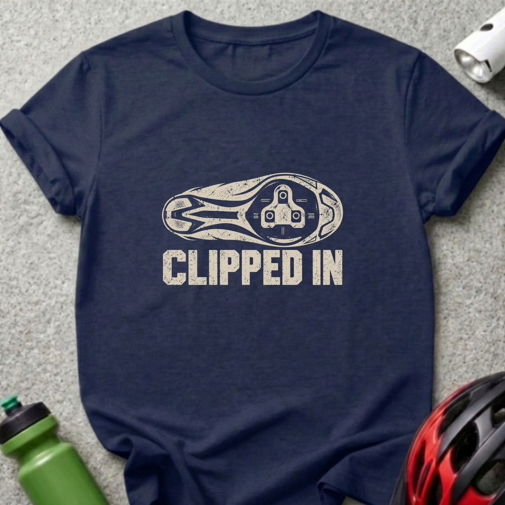 A dark blue crew-neck t-shirt with a distressed graphic of a bicycle cleat and the text CLIPPED IN.