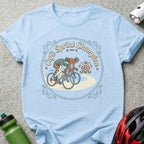 Light blue t-shirt with graphic of two cyclists in a race, "Cafe Sprint Champion" text.