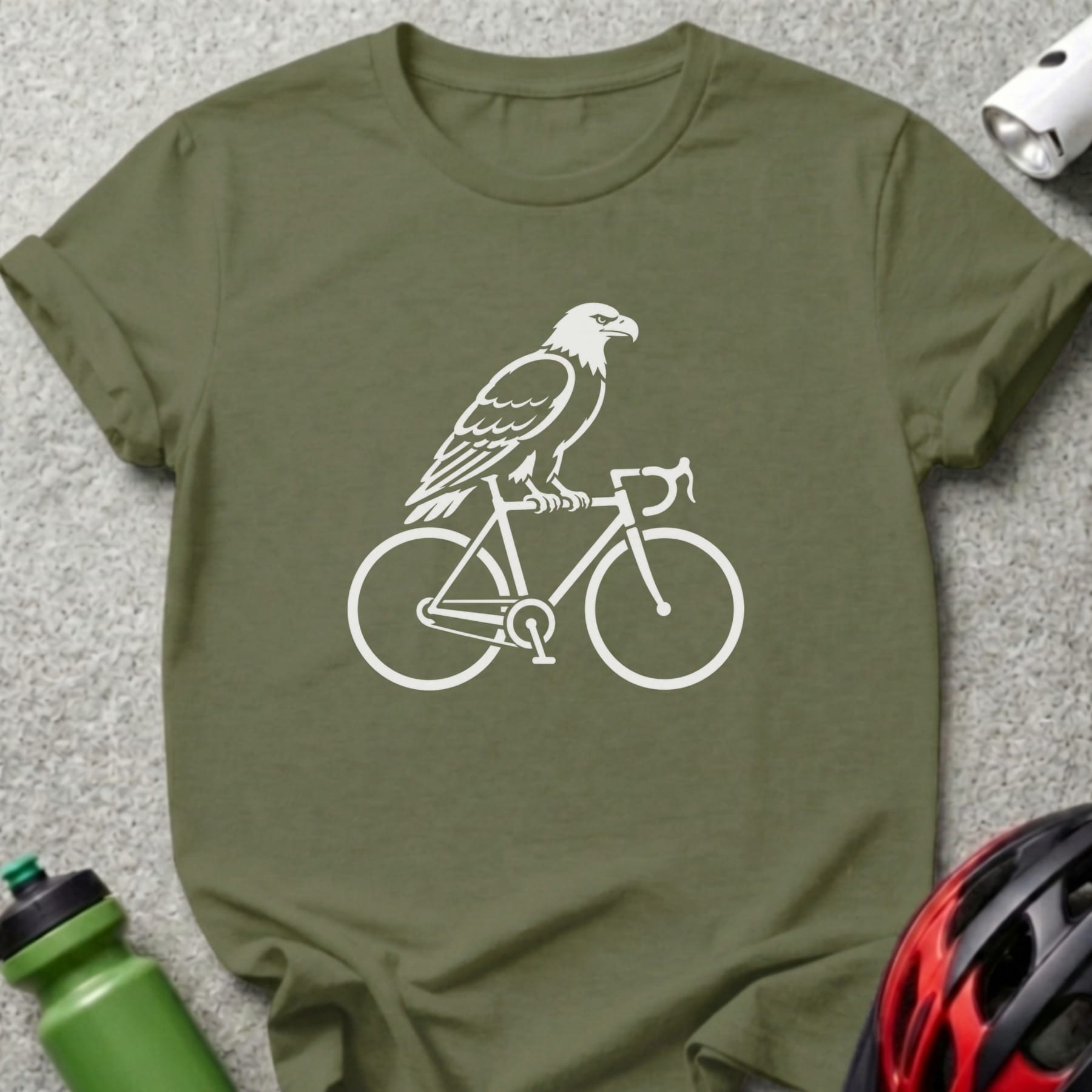 White eagle silhouette riding a bicycle on a green t-shirt.