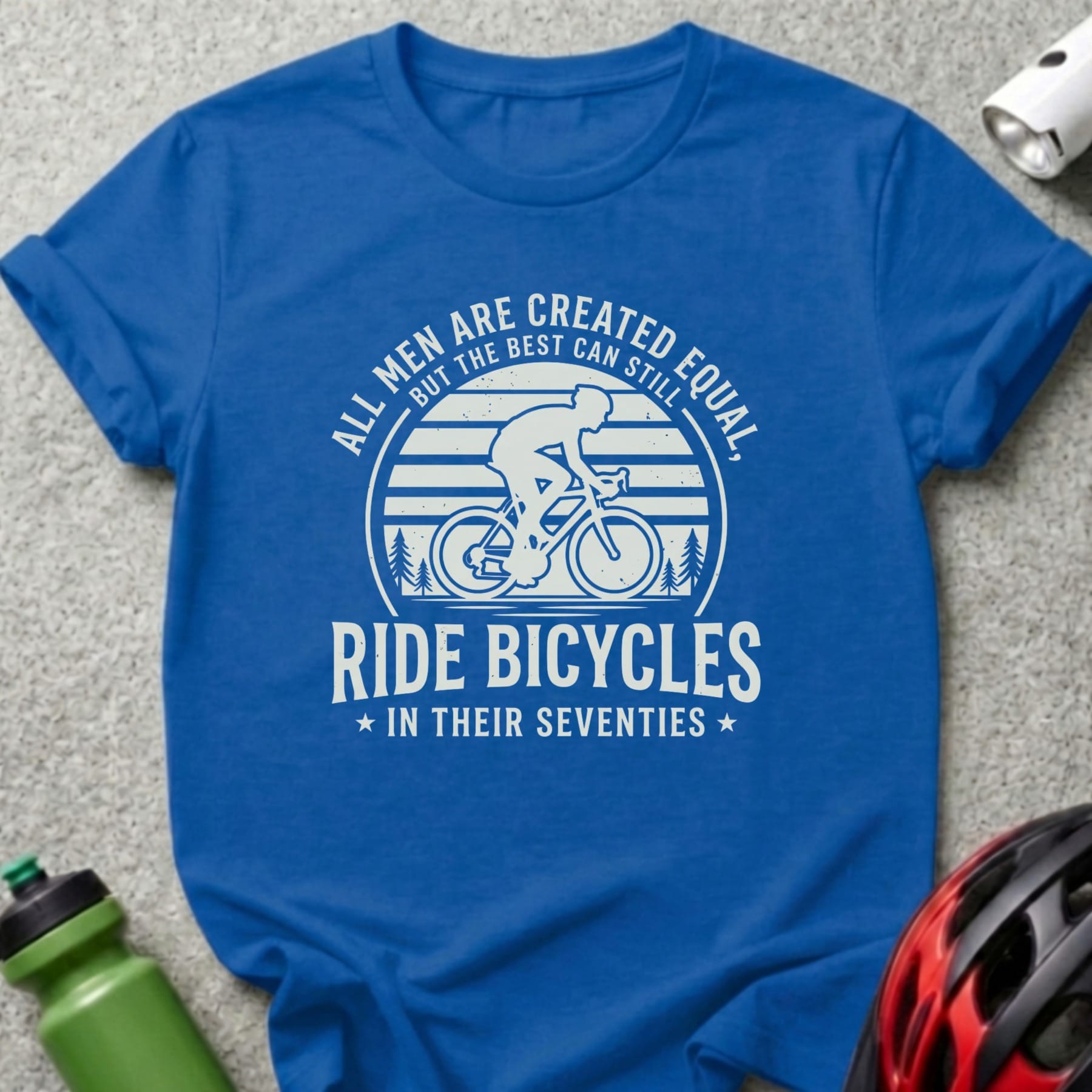 Blue t-shirt with "All men are created equal, but the best can still ride bicycles in their seventies" graphic.