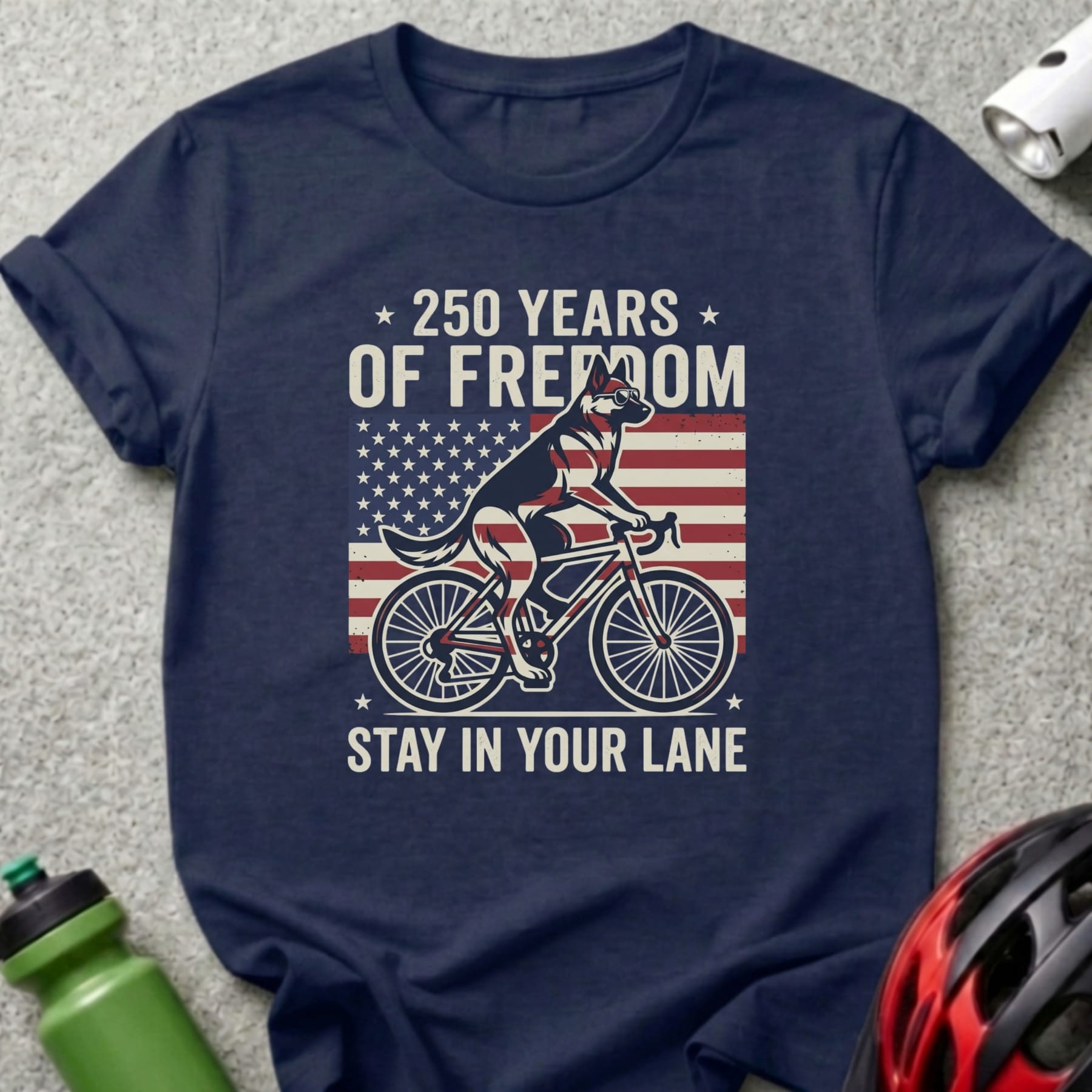 Navy t-shirt with American flag, a dog on a bicycle, and text "250 Years of Freedom. Stay in your lane."