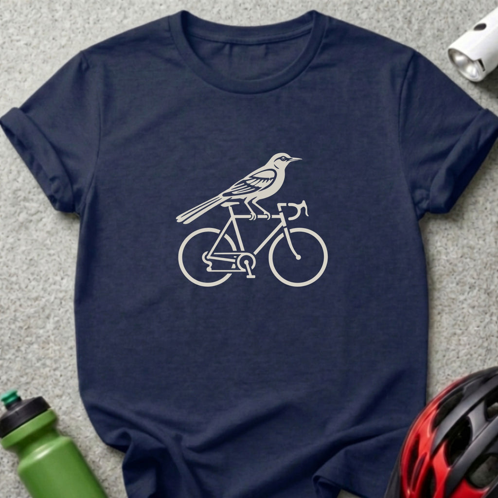 A navy blue crewneck t-shirt featuring a white graphic of a bird perched on a bicycle.