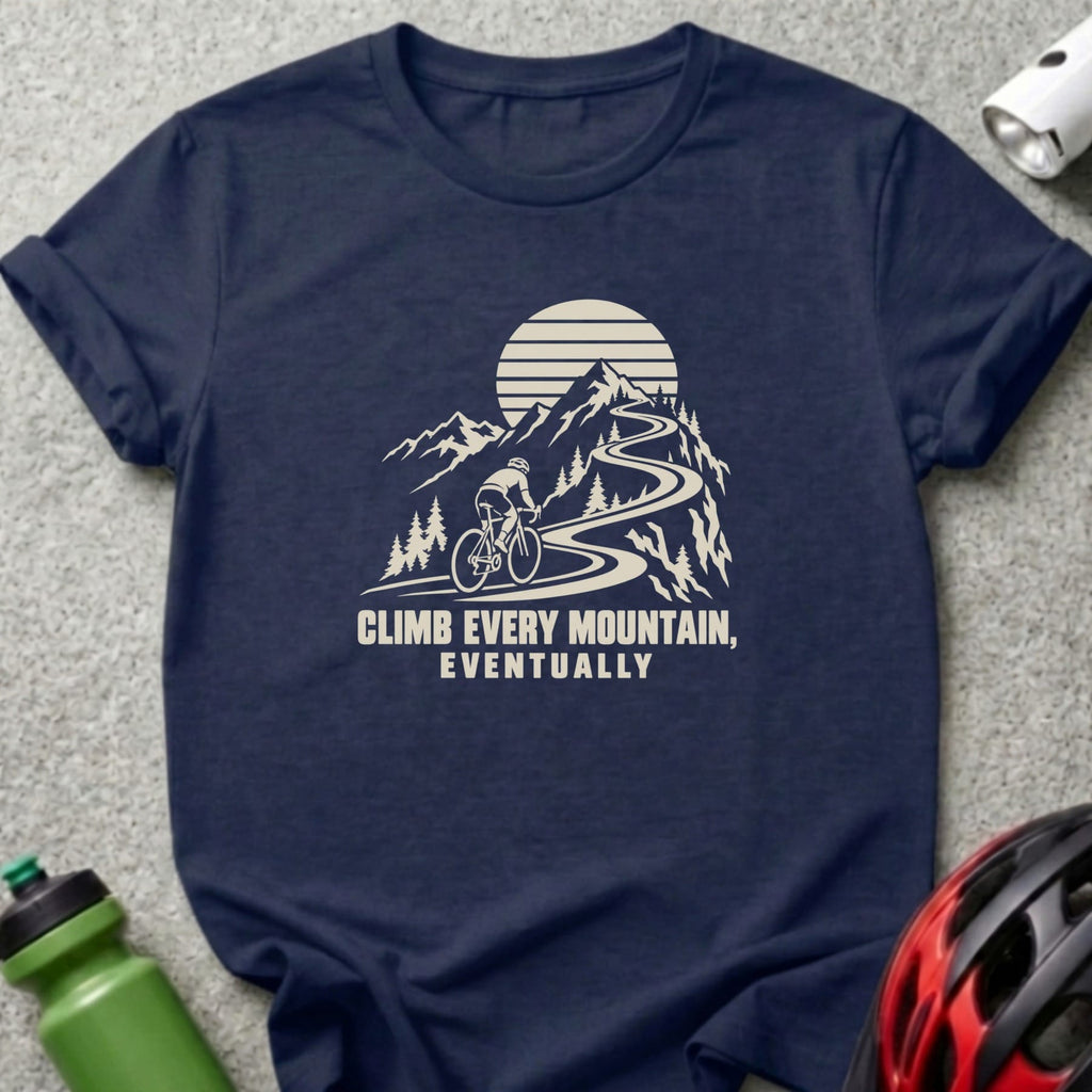 Navy t-shirt with a white graphic of a cyclist climbing a mountain and the text Climb Every Mountain, Eventually.
