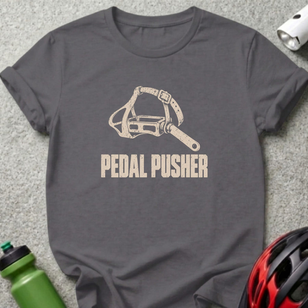 A dark gray t-shirt with a vintage bicycle pedal graphic and the text PEDAL PUSHER.