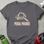 A dark gray t-shirt with a vintage bicycle pedal graphic and the text PEDAL PUSHER.