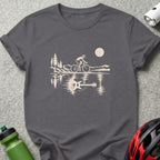 Charcoal gray crewneck t-shirt featuring a graphic of a cyclist riding past mountains, reflected in water as a guitar.