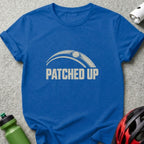 A royal blue t-shirt printed with the text PATCHED UP beneath an arched graphic.