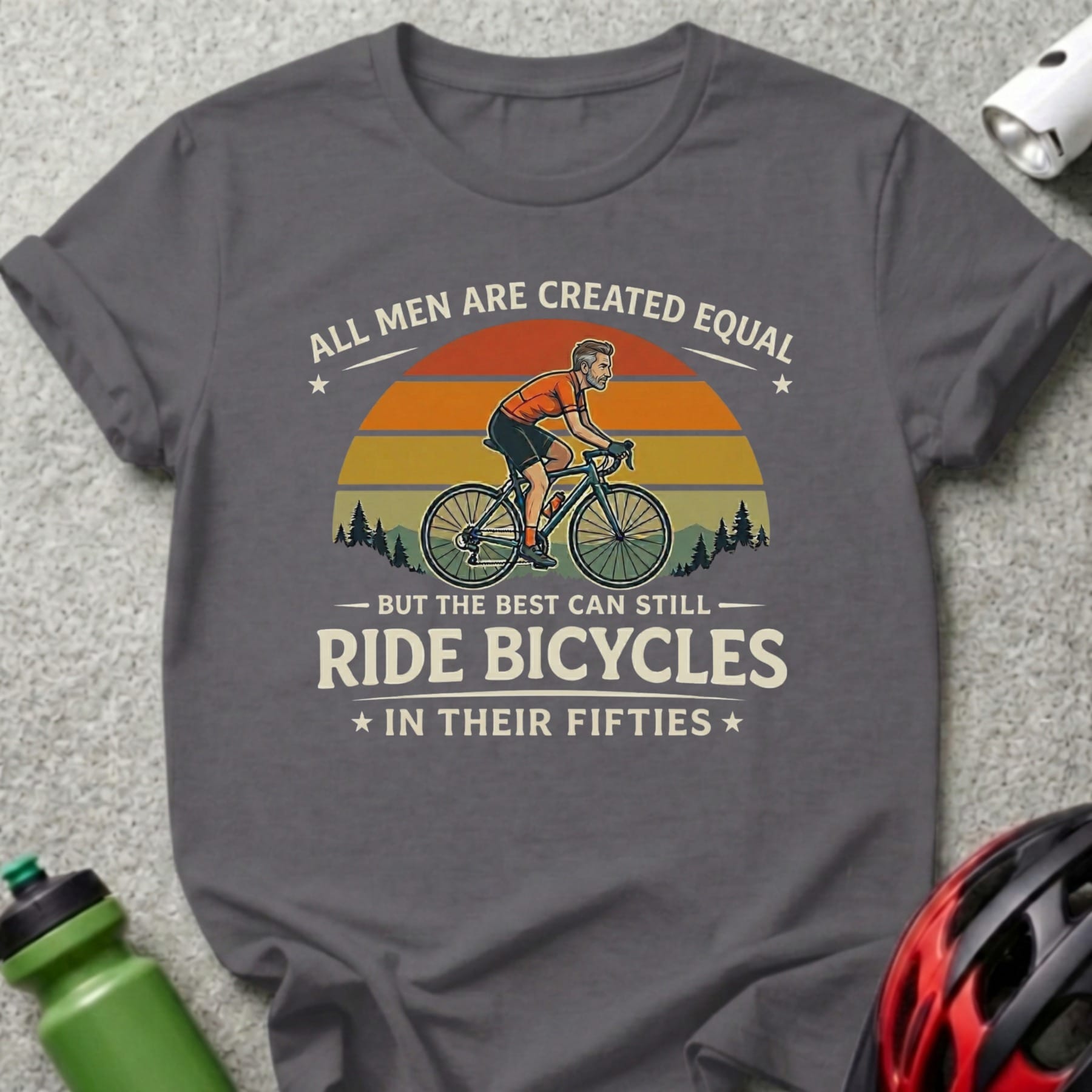 T-shirt with cyclist graphic and text: "All men are created equal but the best can still ride bicycles in their fifties."