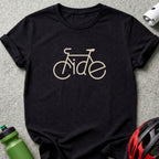 Black t-shirt with a beige outline of a bicycle spelling "Ride"