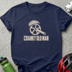 Dark blue t-shirt featuring a bicycle crank graphic wearing a flat cap and the text Cranky Old Man.